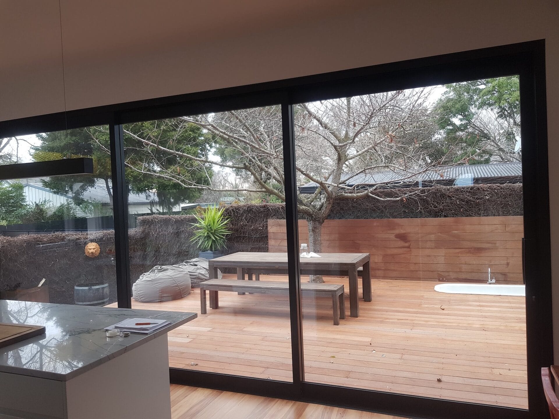 Darling — view from kitchen through triple stacker doors onto the new deck