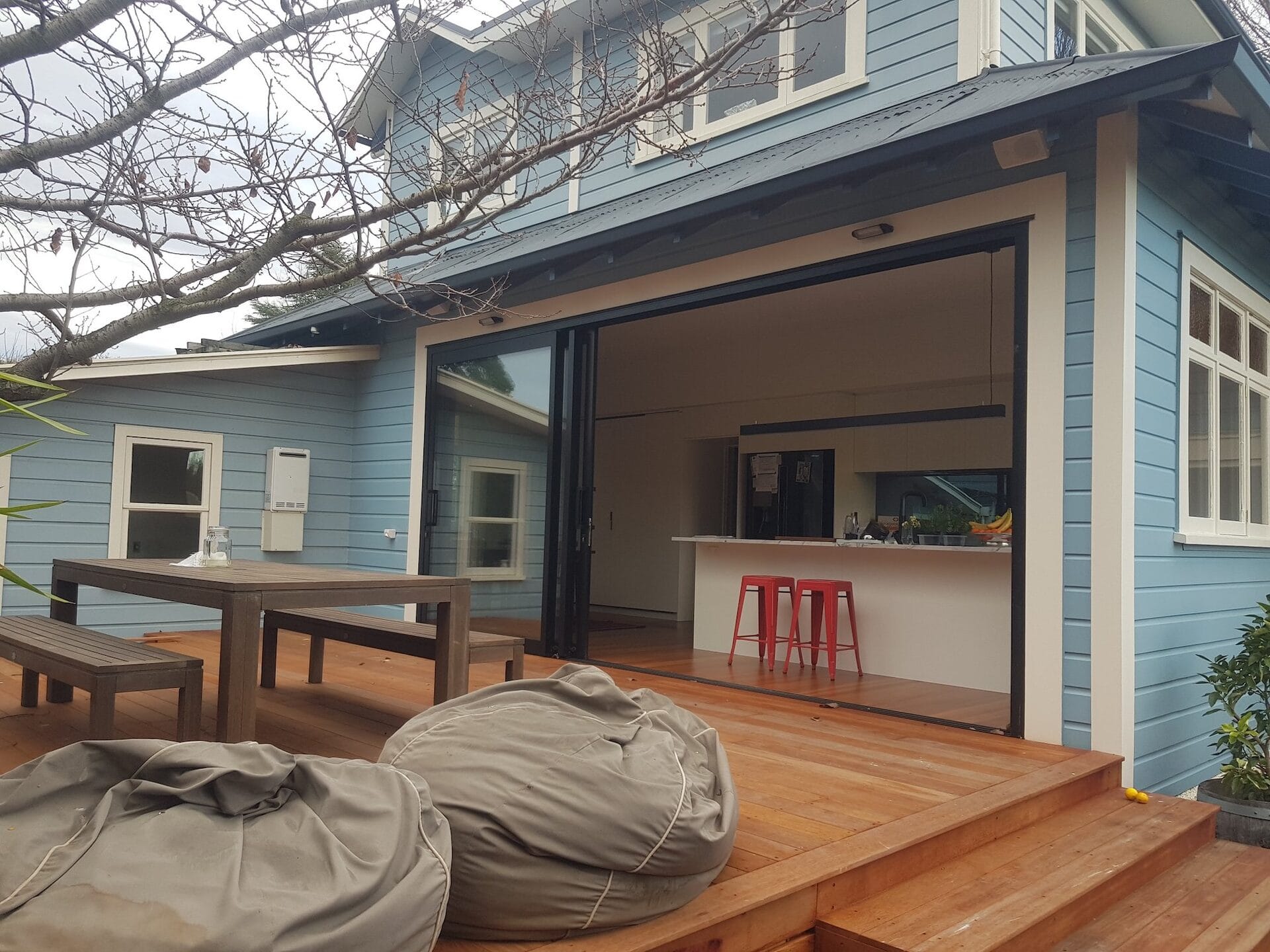 Darling — triple stacker doors open, connecting kitchen and deck