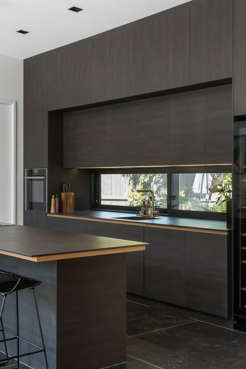David Street kitchen, dark joinery with timber accents and integrated appliances