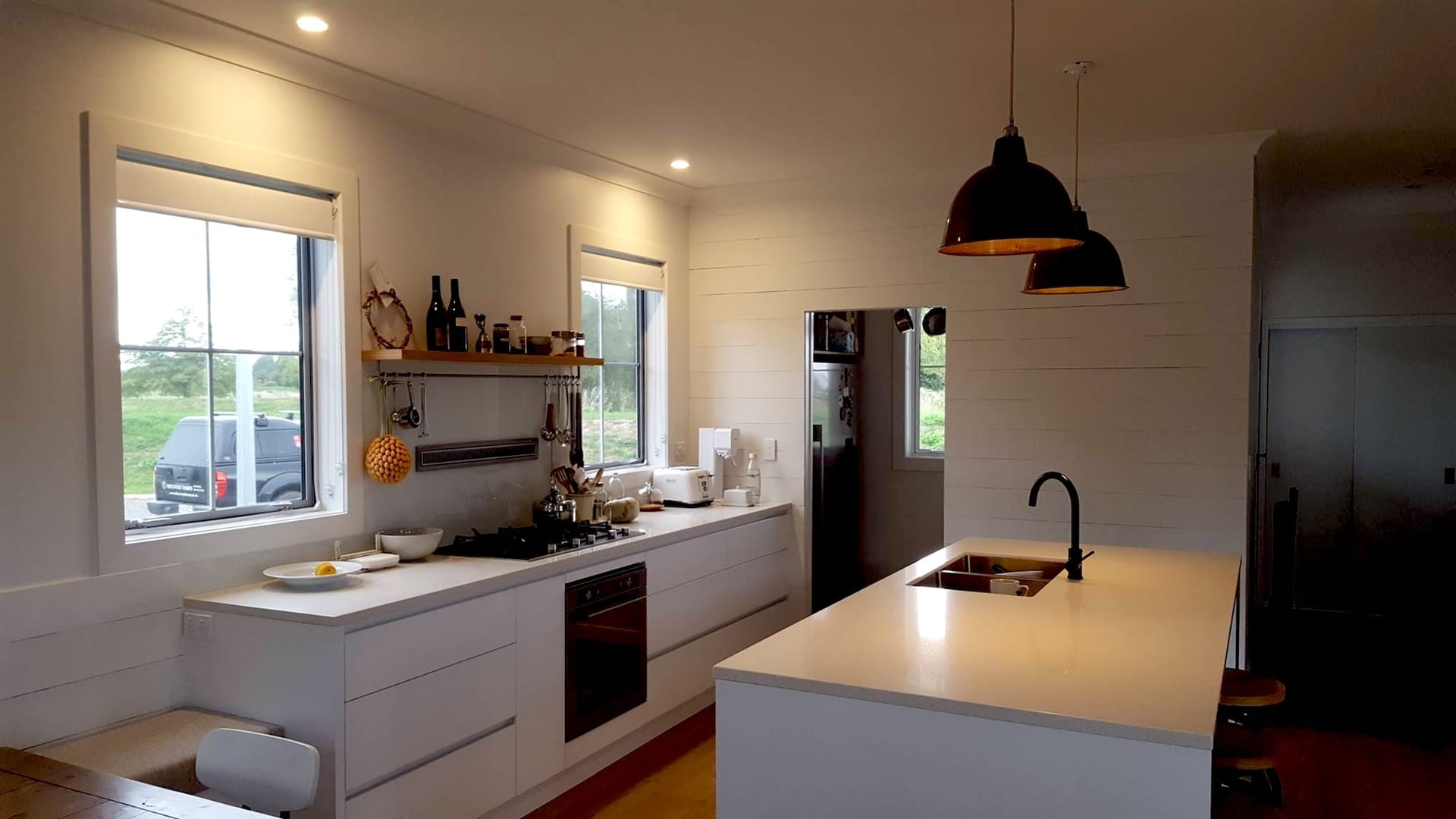 White kitchen with restored industrial pendant lighting