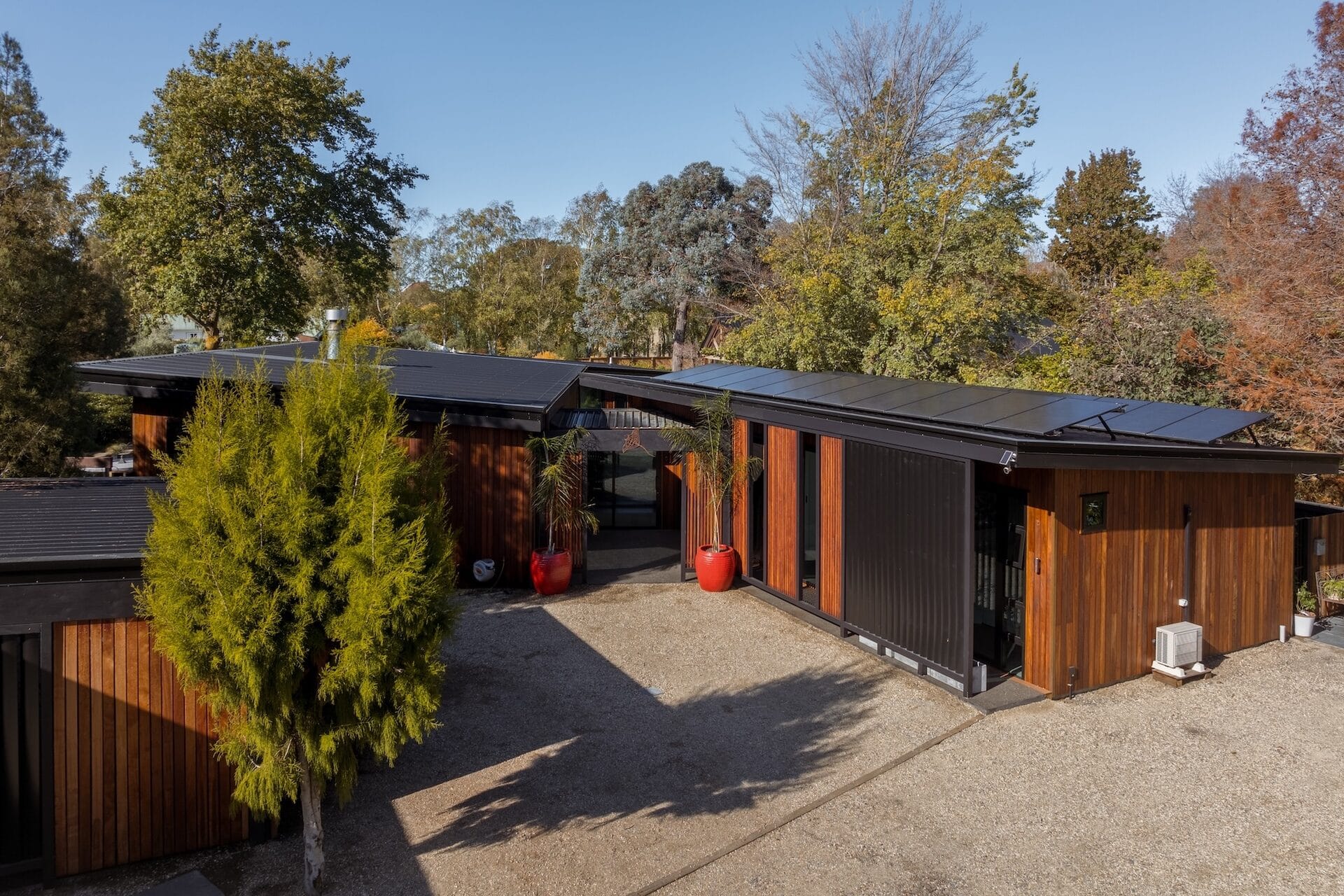 Discovery Homes custom new build with cedar cladding and solar panels, set among mature trees in Marlborough