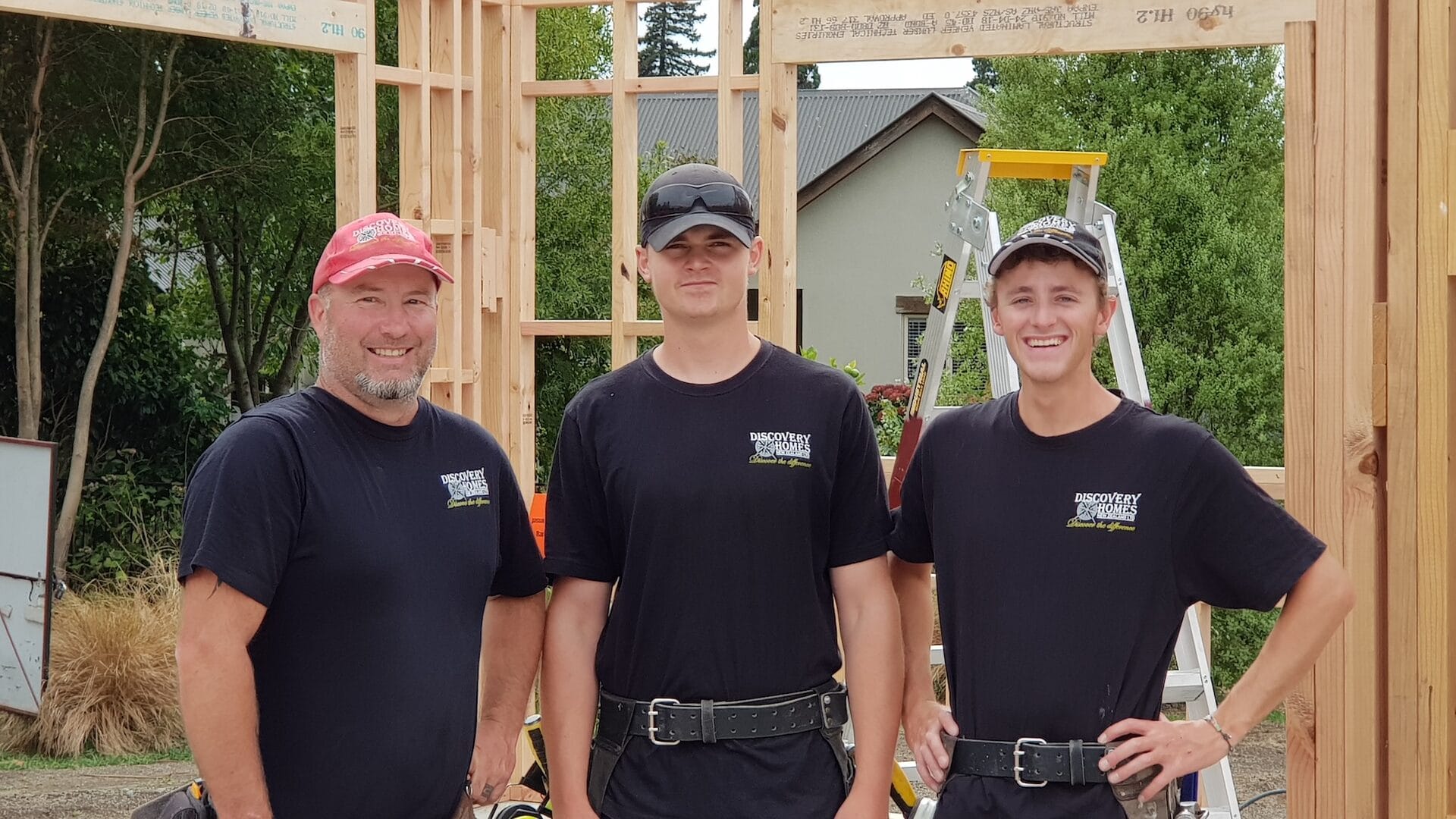 Ben Grady on site with the Discovery Homes team, in front of a timber-framed new build in Marlborough