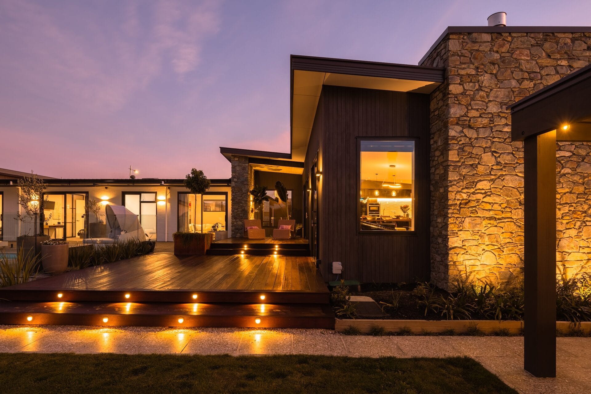 Pope Home — exterior with lit deck steps